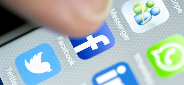 Male Finger is Touching Facebook App on iPhone 6 Screen